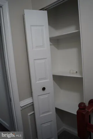 a view of a small space with wooden floor and a window