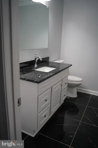 a close view of a sink a mirror and a stove in a kitchen