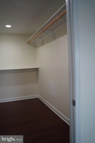 a view of a small space with wooden floor and a window
