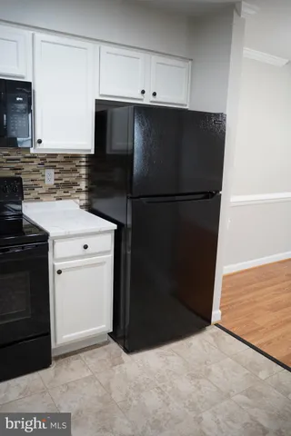 a kitchen with a refrigerator and a stove