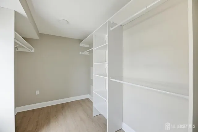 an empty room with windows and closet