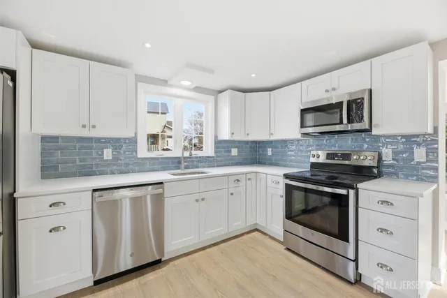 a view of kitchen with wooden floor