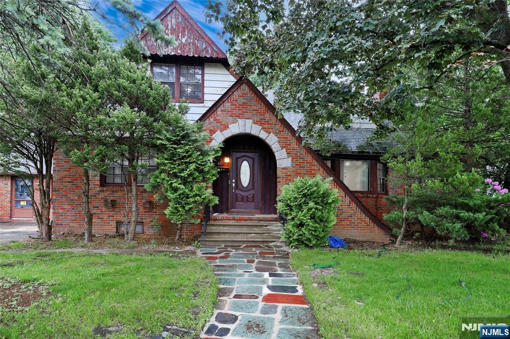 a front view of a house with garden