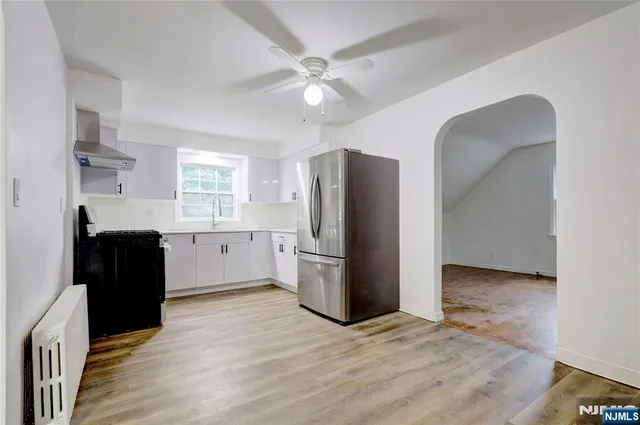 a kitchen with a refrigerator cabinet and a sink