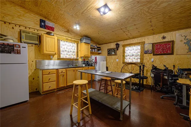 a kitchen with a sink appliances and cabinets