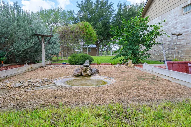 a view of a backyard with large tree