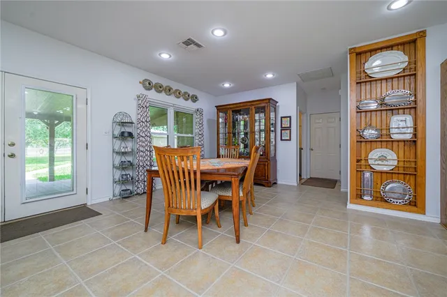 a dining room with furniture and window