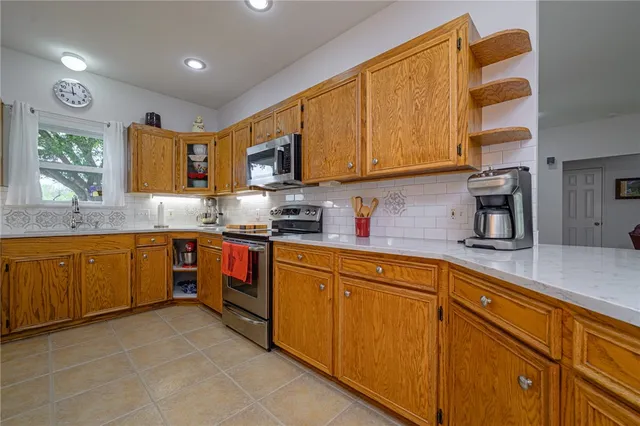 a kitchen with stainless steel appliances granite countertop a sink and cabinets