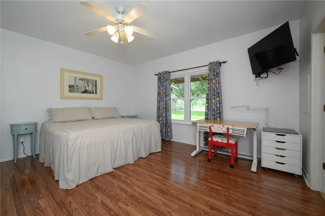 a bedroom with a bed and a tv on table