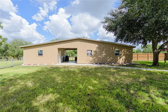 a view of a backyard with a garden and tree