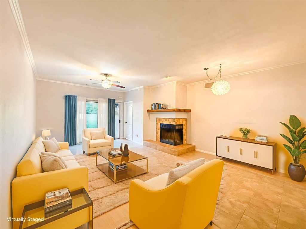 a living room with furniture a fireplace and chandelier