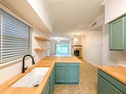 a large kitchen with a sink and a large window