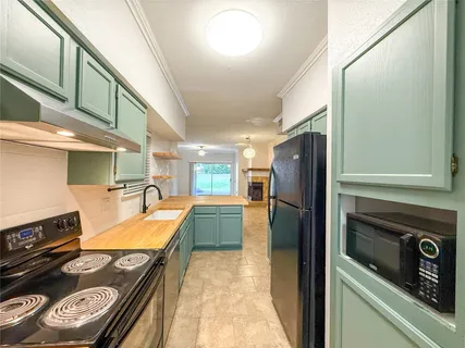 a kitchen with refrigerator and stove