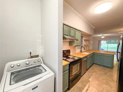 a kitchen that has a sink and a stove