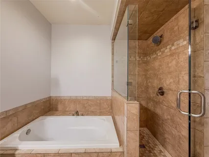 a bathroom with a bath tub and shower