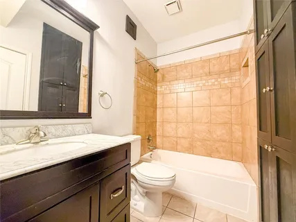 a bathroom with a sink a toilet a mirror and shower