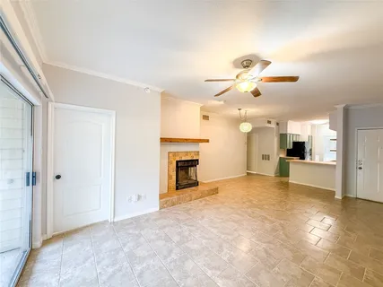 an empty room with fireplace and windows
