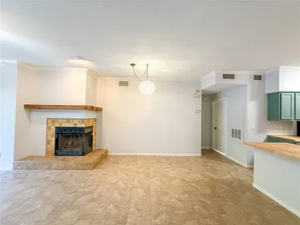 an empty room with a fireplace and fan