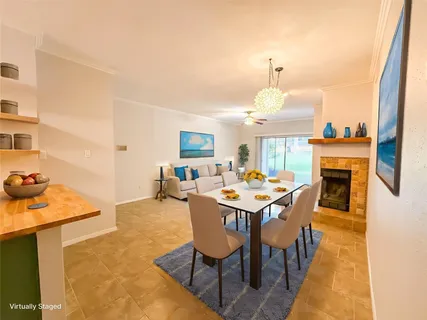 a dining room with furniture a rug and a chandelier