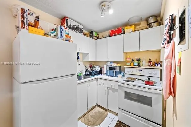 a kitchen with stainless steel appliances a refrigerator and a stove top oven