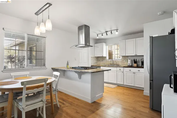 a bedroom with a bed a table and a large window