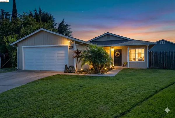 a front view of house with a garden