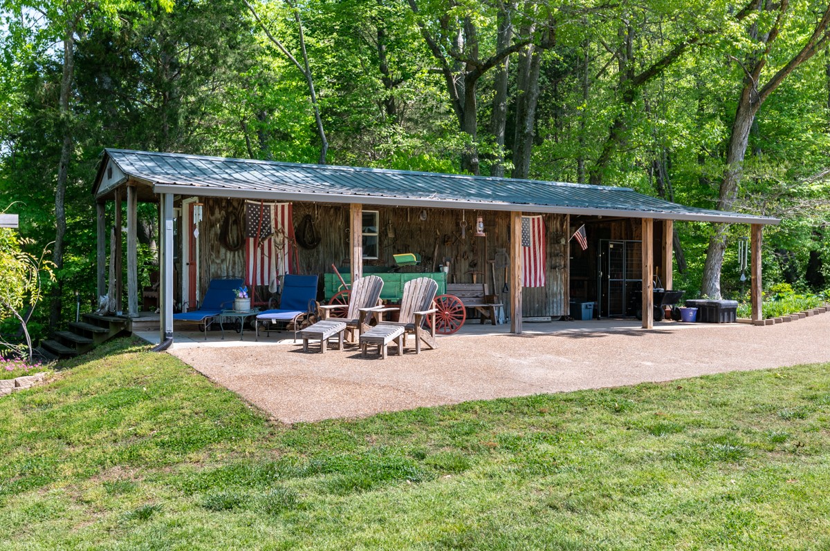 450 North Denny Road Lebanon, TN 37087 - Photo 51 of 65 a view of a patio with table and chairs under an umbrella with large trees