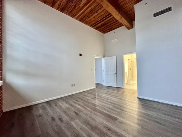 a view of an empty room and wooden floor