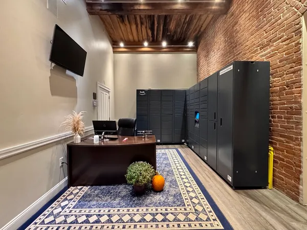 a kitchen with stainless steel appliances kitchen island granite countertop a refrigerator and a sink