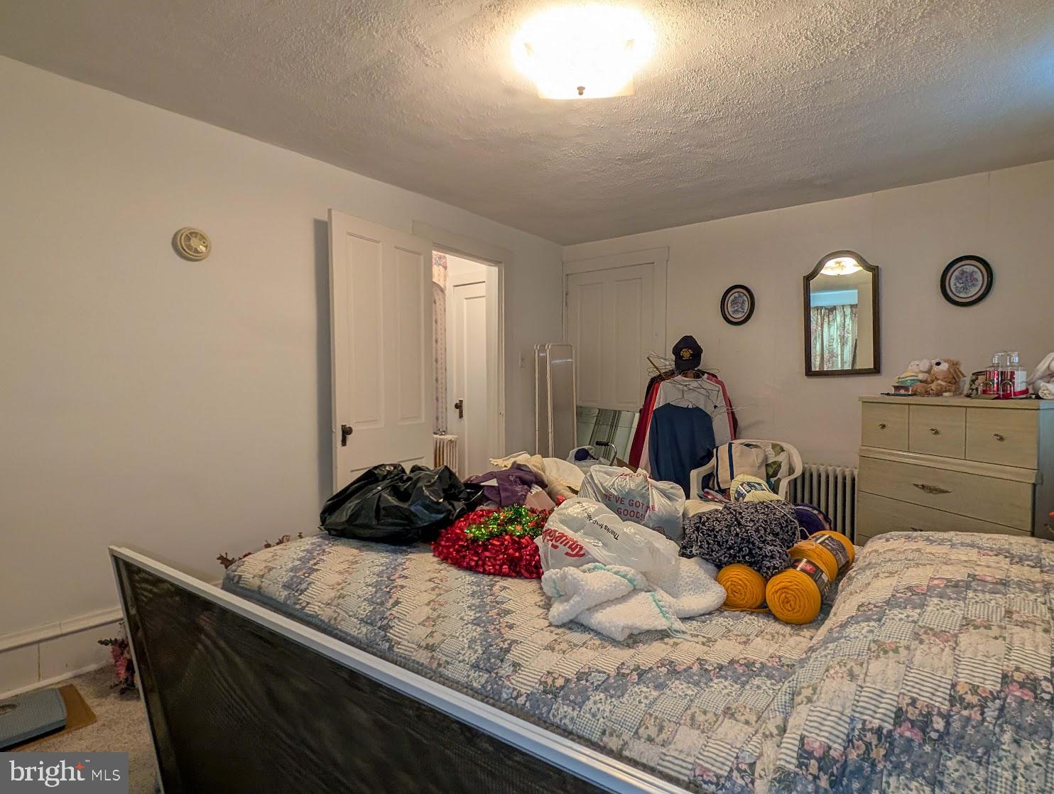 601 16th Street Saxton, PA 16678 - Photo 18 of 57 a bedroom with a bed and a lamp on dresser