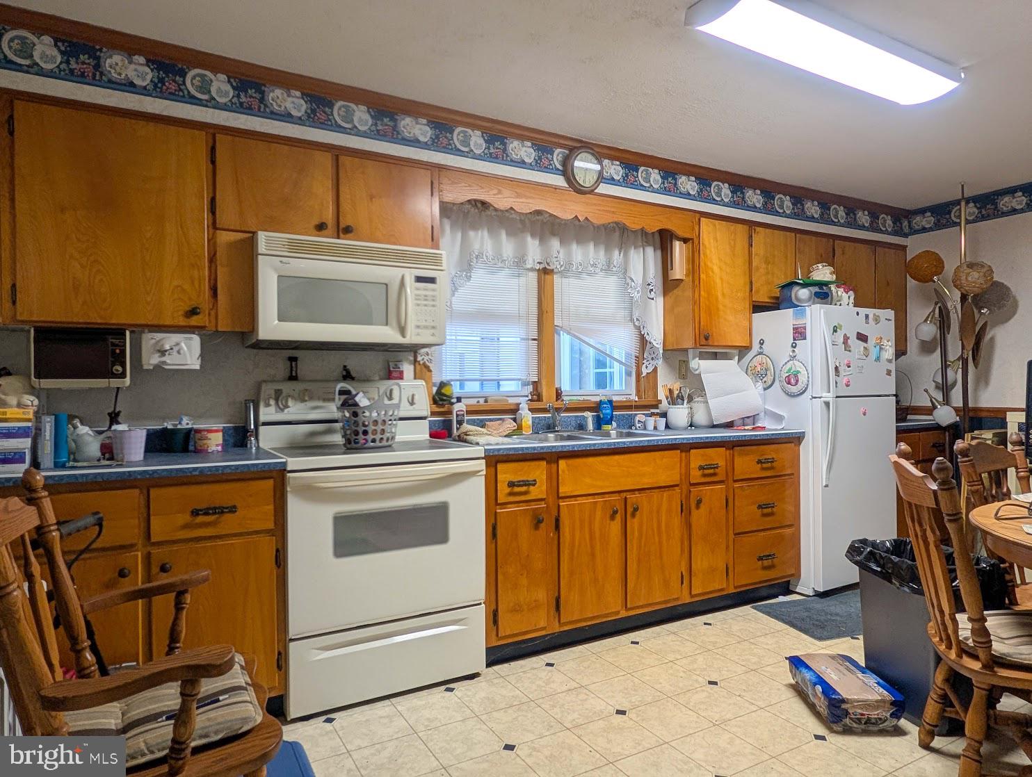 601 16th Street Saxton, PA 16678 - Photo 19 of 57 a kitchen with stainless steel appliances granite countertop sink stove and refrigerator