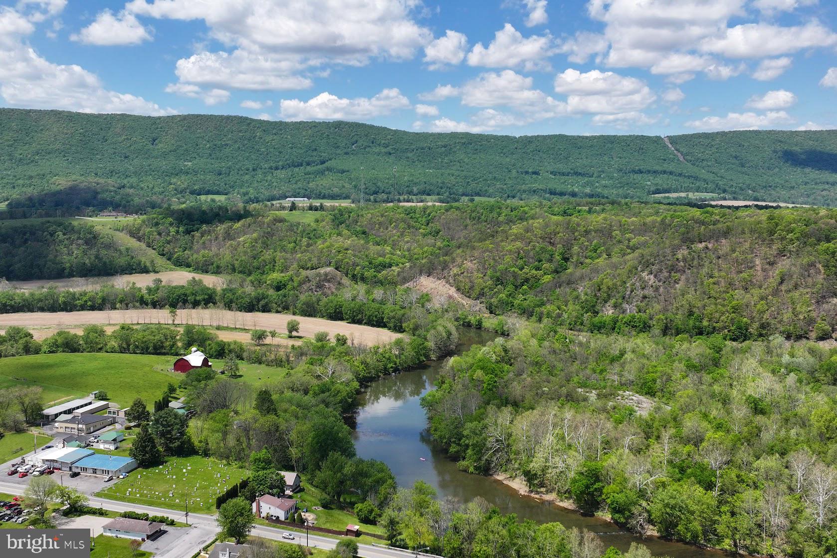601 16th Street Saxton, PA 16678 - Photo 51 of 57 a view of a lush green forest with lots of residential buildings and mountain view in back