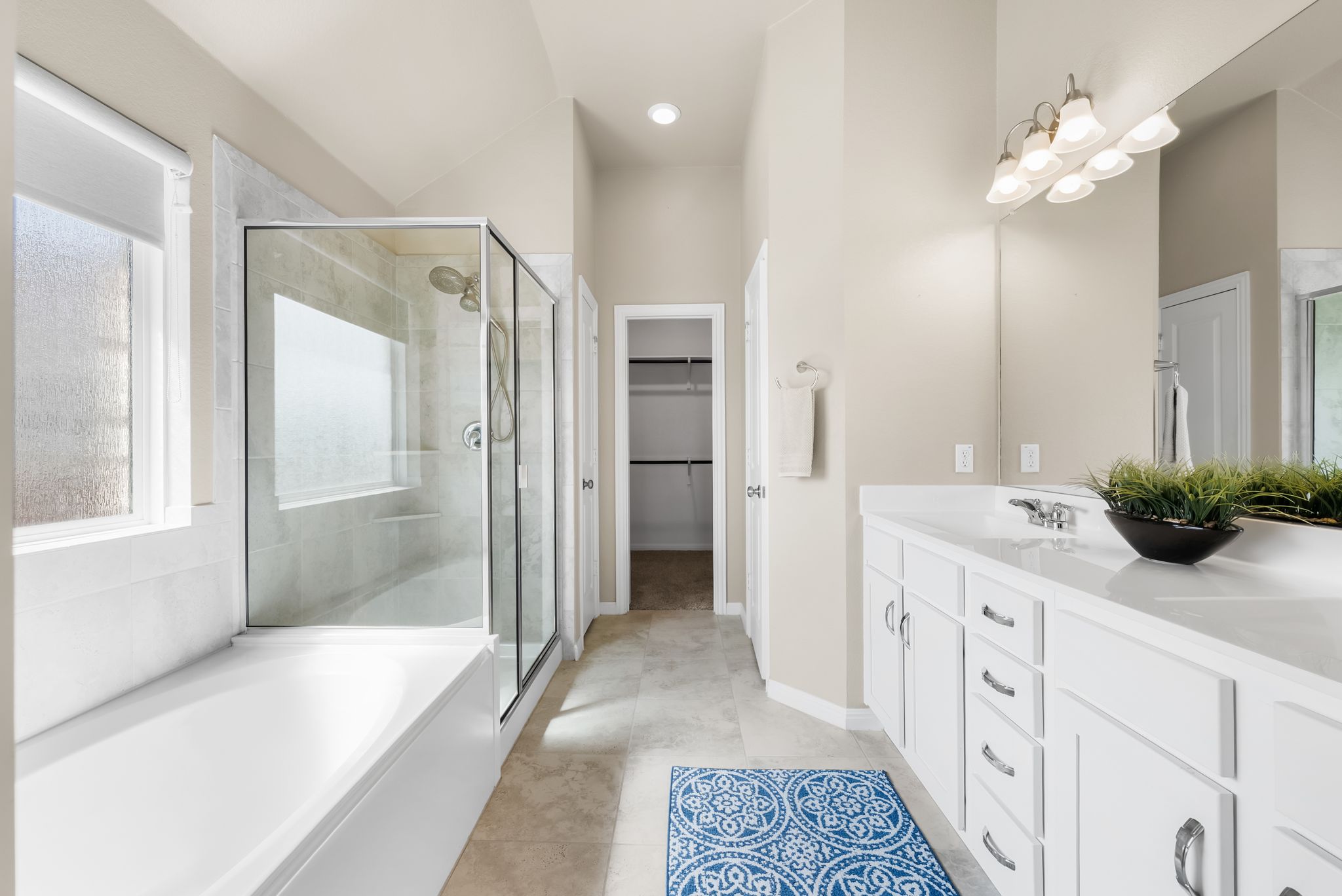 300 Prato Place Georgetown, TX 78628 - Photo 18 of 40 Indulge in this well-appointed bath, offering a spacious tub, walk-in shower, and ample vanity space.
