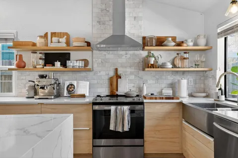 a kitchen with stainless steel appliances granite countertop a sink and cabinets
