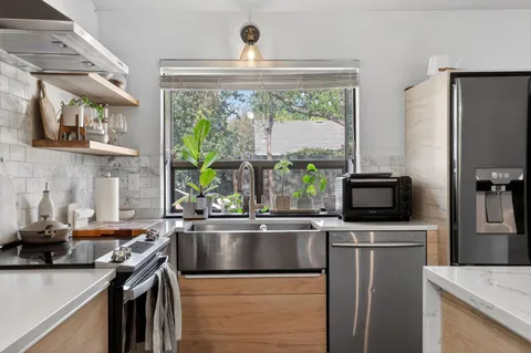 a kitchen with a sink stove and microwave