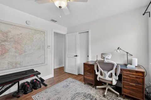 a living room with furniture and a dresser