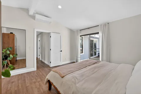 a spacious bedroom with a bed and a potted plant