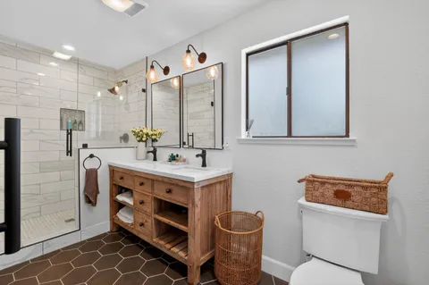 a bathroom with a double vanity sink mirror and