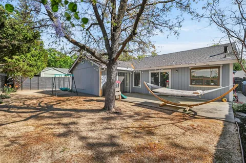 a house that has a tree in front of it