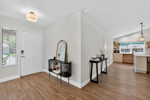 a dining room with furniture wooden floor a rug and a painting