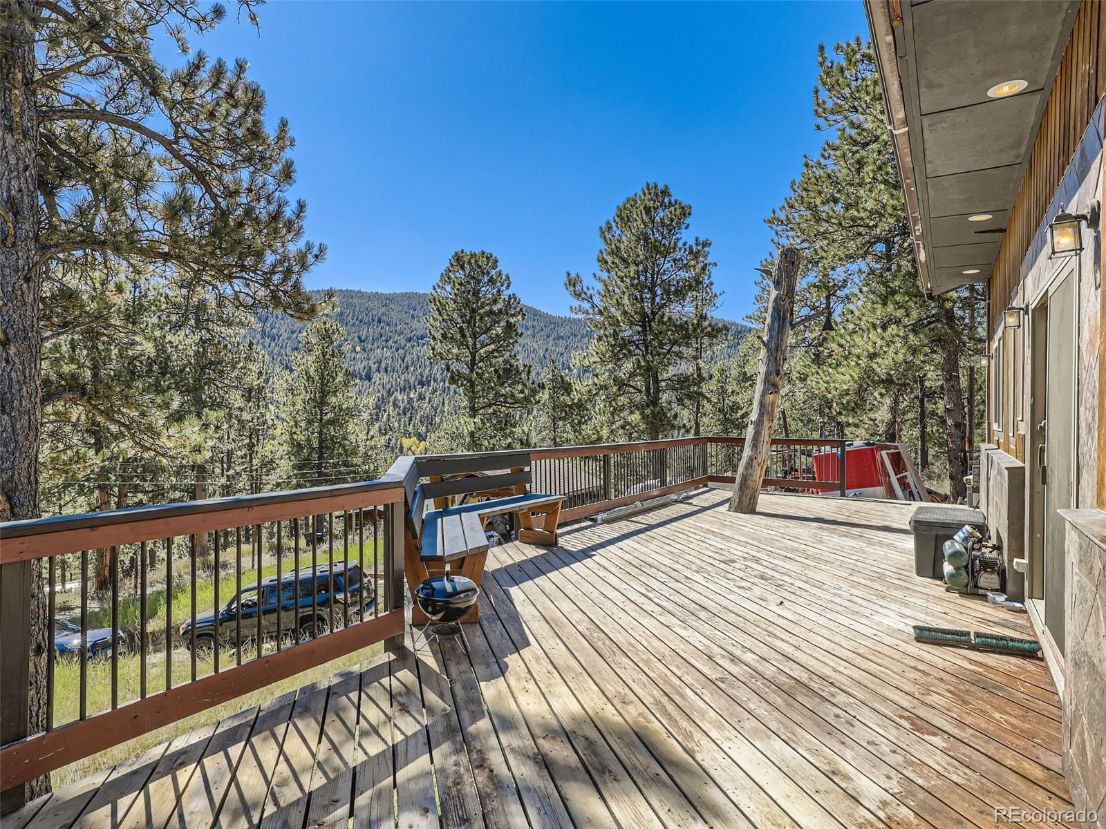 33657 Valley View Drive Evergreen, CO 80439 - Photo 13 of 13 a view of a balcony with chairs and wooden floor