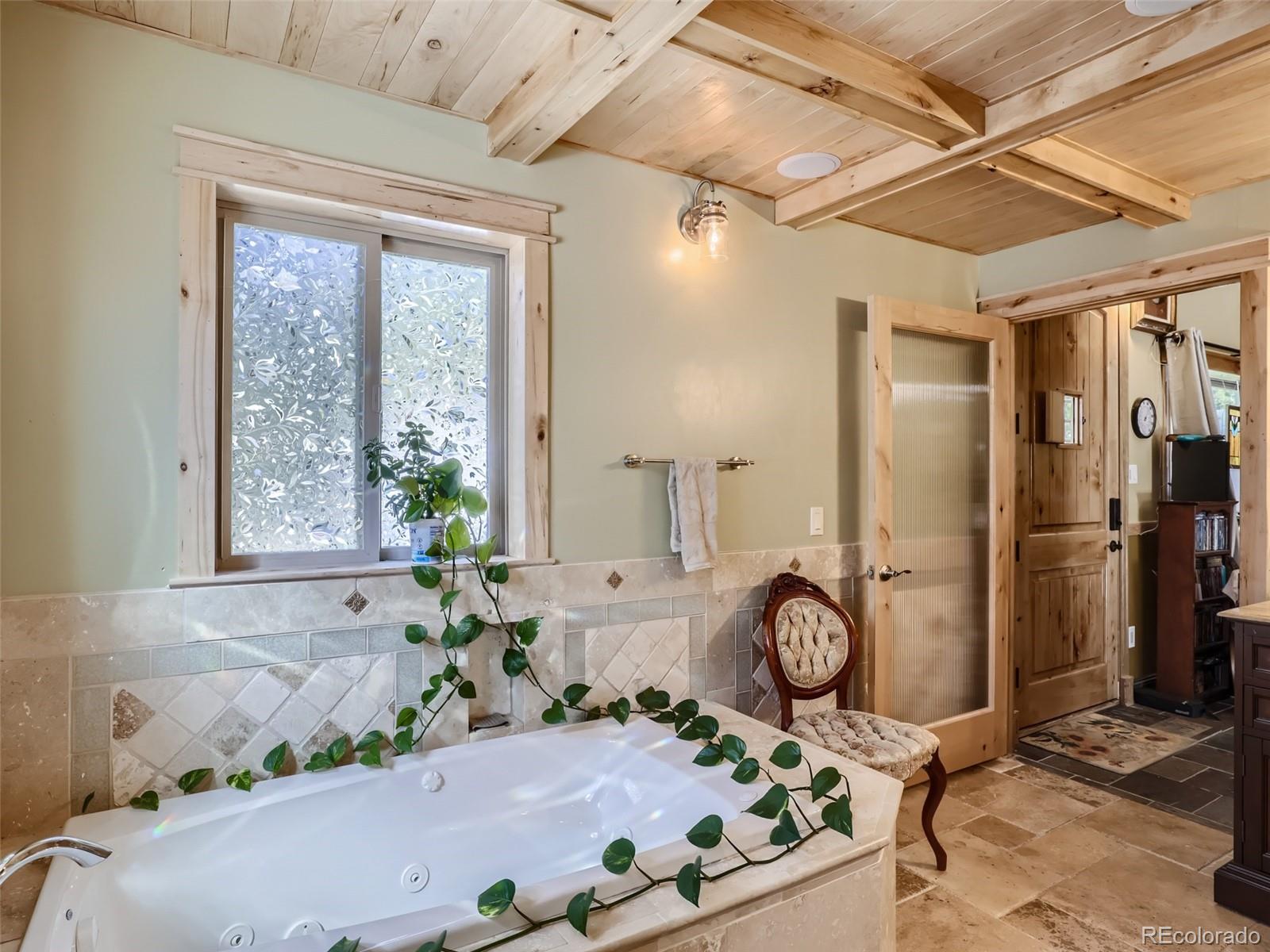 33657 Valley View Drive Evergreen, CO 80439 - Photo 4 of 13 a bath tub sitting in a bathroom next to a window