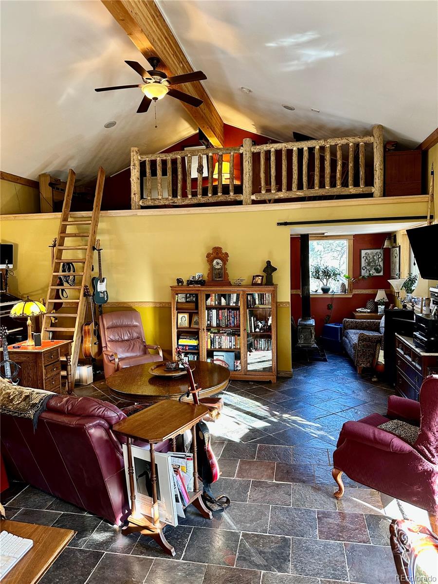 33657 Valley View Drive Evergreen, CO 80439 - Photo 6 of 13 a living room with furniture and a book shelf