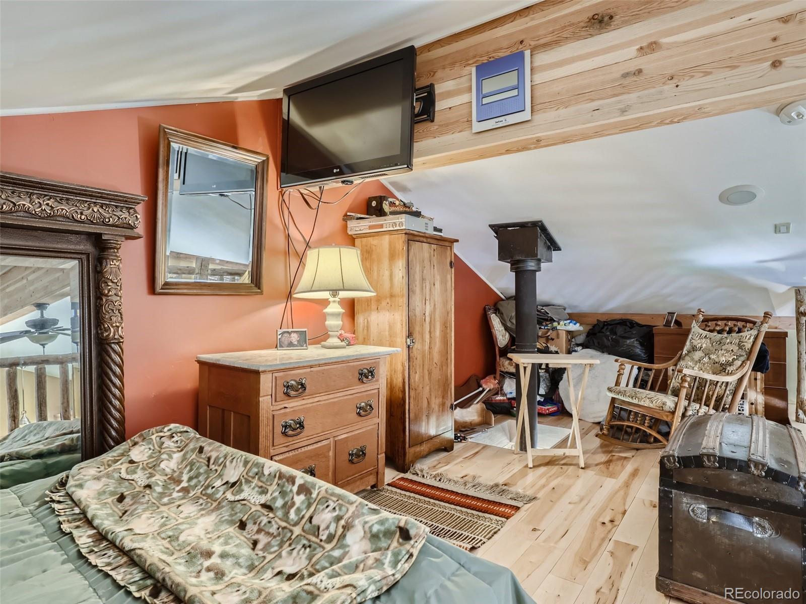 33657 Valley View Drive Evergreen, CO 80439 - Photo 9 of 13 a living room with furniture and a flat screen tv