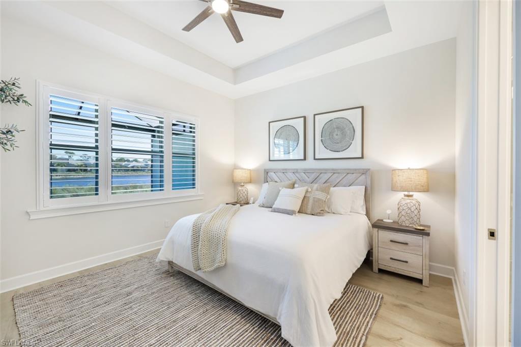 6295 Arriba Avenue Naples, FL 34113 - Photo 14 of 34 a bedroom with a bed and a night stand