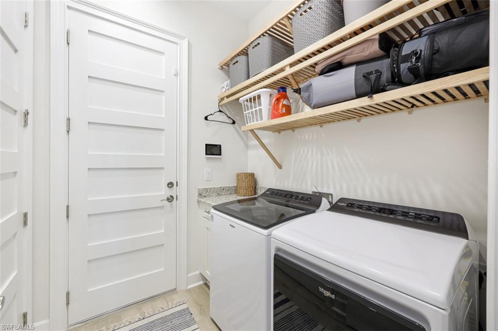 6295 Arriba Avenue Naples, FL 34113 - Photo 21 of 34 a utility room with dryer and washer
