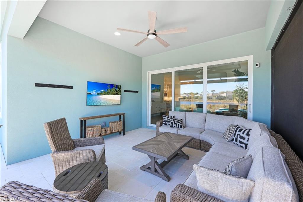 6295 Arriba Avenue Naples, FL 34113 - Photo 23 of 34 a living room with furniture and a large window
