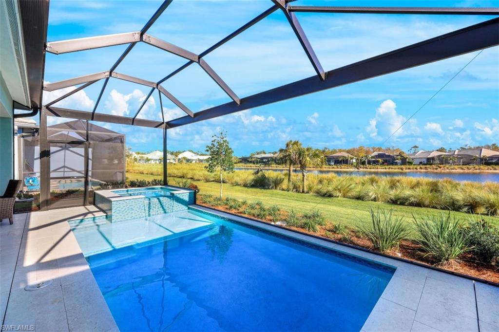 6295 Arriba Avenue Naples, FL 34113 - Photo 26 of 34 a view of an ocean with a floor to ceiling window
