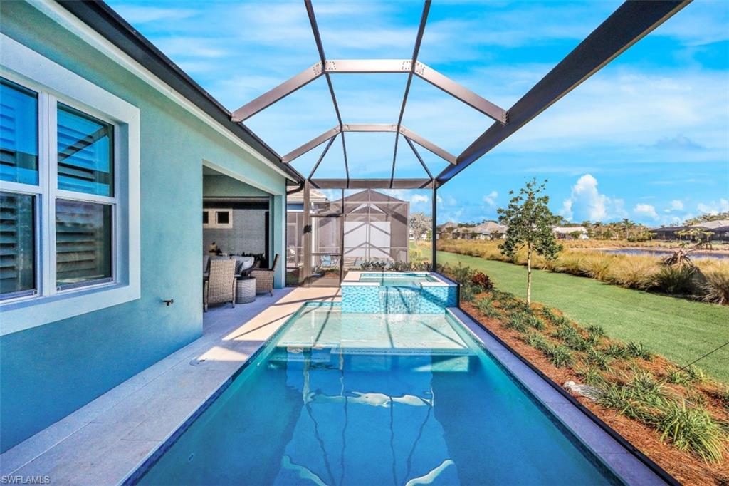 6295 Arriba Avenue Naples, FL 34113 - Photo 27 of 34 a view of a backyard with a patio and wooden floor