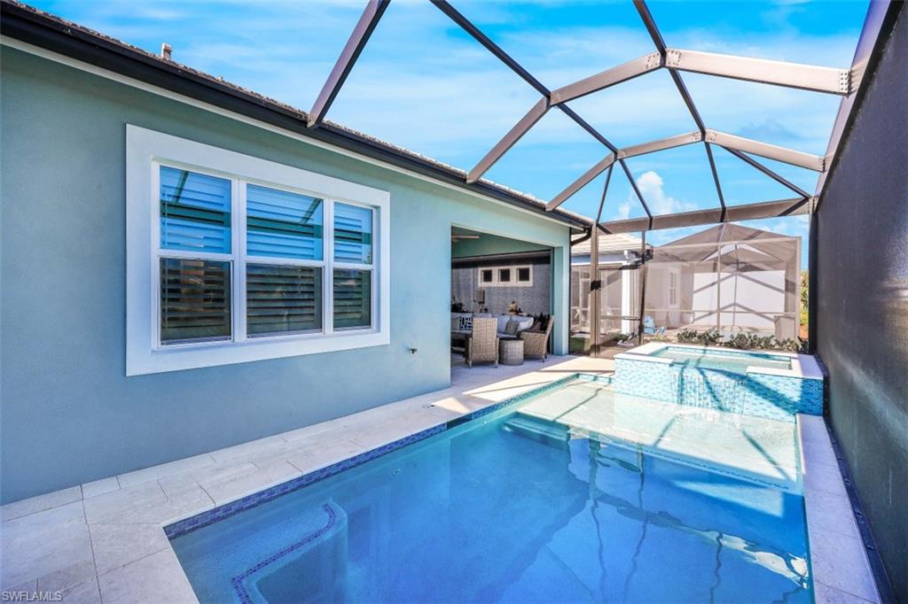6295 Arriba Avenue Naples, FL 34113 - Photo 28 of 34 a swimming pool with outdoor seating